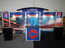 RENTAL:  RE-2009 Arch Canopy, Halogen Arm Lights, RE-1202 Counter, (2) RE-1201 Counters, and Clear Acrylic Shelves. Tension Fabric Graphics, and Sintra Header and Counter Graphics -- Image 1