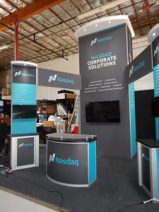 RENTAL: Custom Island with 16' High Tower with White Laminated Soffits with Recessed Puck Lights, Storage Closet with Locking Door, Bridged Headers, Double-Sided Workstation Kiosks with RE-1227 Counters, RE-1250 Reception Counter, RE-1228 Small Curved Cou