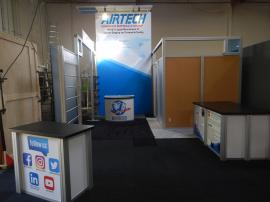 RENTAL: Custom 20&rsquo; x 50&rsquo; Island Design with 16&rsquo; High Double-Sided Tower with Extrusion Canopy, Storage Closet, Conference Room, Storage Room, Frosted Acrylic and Sintra Infill Panels, SEG Fabric Graphics, Large Custom Counter, RE-1202 Rectangular Co